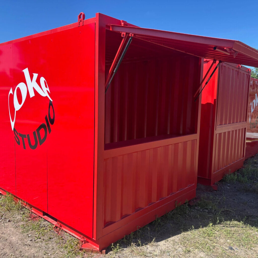 Red shipping container pop-up kiosk with a serving hatch